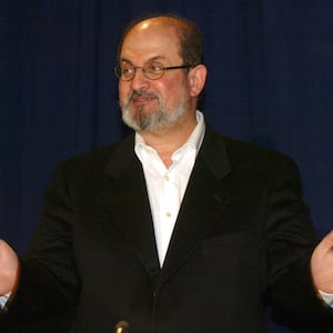 Salman Rushdie gestures to the audience in Vienna on April 15, 2002.