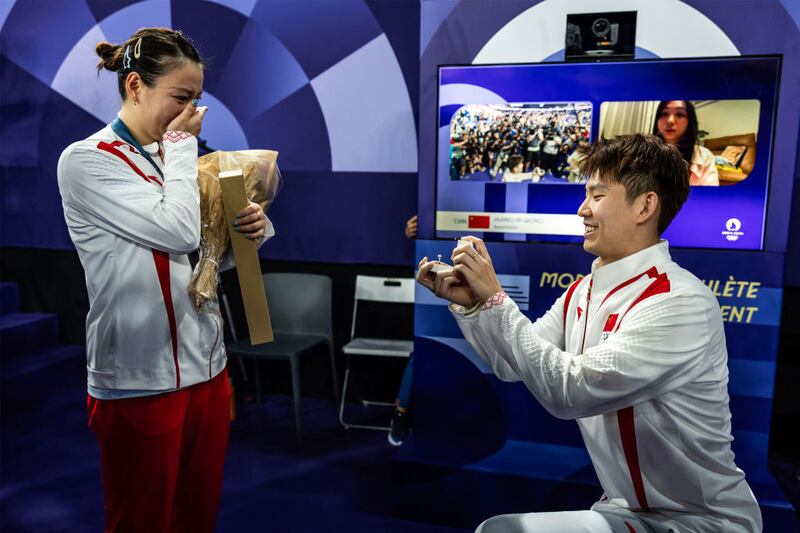 Yaqiong puts her hands to her mouth in shock as her then-boyfriend proposes to her.