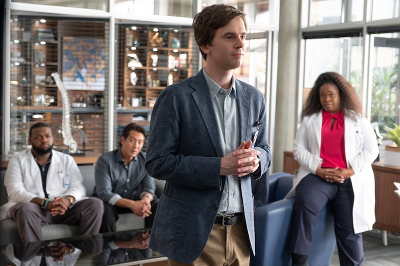 Freddie Highmore sits in front of the cast of ‘The Good Doctor’