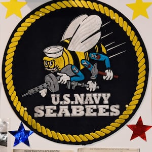 A photo of a U.S. Navy Seabees logo and associated ephemera.