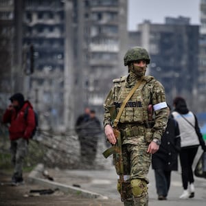 A Russian soldier patrols in a street of Mariupol 