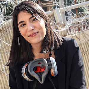 Lebanese Al-Mayadeen tv reporter Farah Omar looks on during the coverage of a demonstration in Beirut on April 18, 2023.