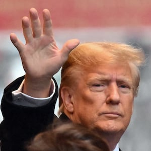 Former President Donald Trump waves as he departs for his sexual assault defamation trial in New York