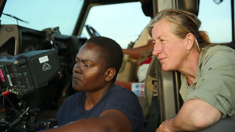 Photo of Cinematographer and mentee Erica Rugabandana reviews her footage with Queens series director of photography Justine Evans.