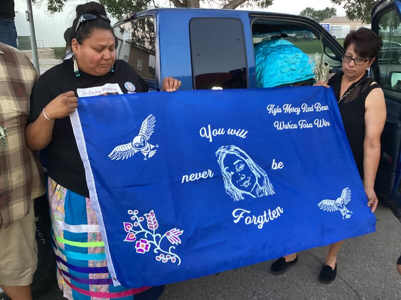 Tasha His Law, a cousin of Kyla Mercy Red Bear, holds a memorial banner with Jen Red Bear, the mother of the woman found dead on Aug. 8.