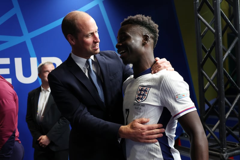 Prince William, Prince of Wales and President of The Football Association, congratulates Bukayo Saka