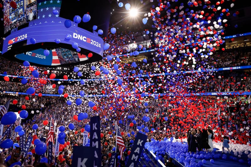 Balloons fall as Democratic presidential nominee Kamala Harris celebrates with her family after accepting the Democratic presidential nomination.