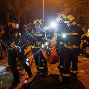 Emergency staff carry a wounded local resident at a site of an apartment building damaged during a Russian missile strike, amid Russia’s attack on Ukraine, in Kyiv, Ukraine December 13, 2023.