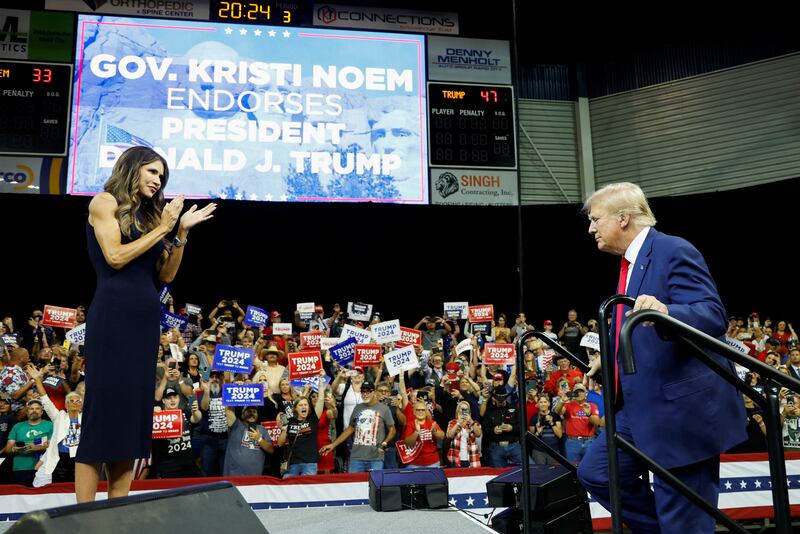 Kristi Noem welcomes Donald Trump on a stage in South Dakota.