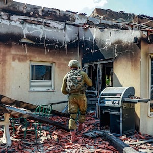  Israeli forces are seen among the rubble of buildings destroyed after the clashes between Israeli and Palestinian forces in Be'eri, Israel 