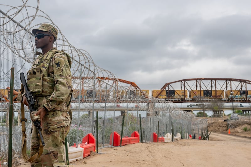 A Texas National Guard soldier patrols near the Rio Grande river at Shelby Park in Eagle Pass, Texas. 