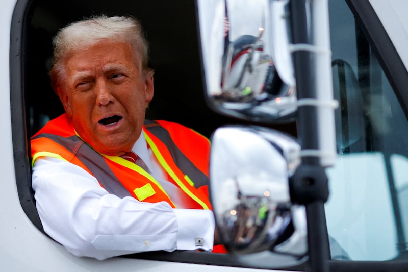 Republican presidential nominee and former U.S. President Donald Trump reacts as he sits in a garbage truck, in Green Bay, Wisconsin, U.S., October 30, 2024. REUTERS/Brendan McDermid