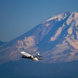 An Alaska Airlines jet passes in front of Mt. Rainier.