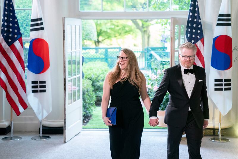 A woman in a dress and a man in a tuxedo in the White House