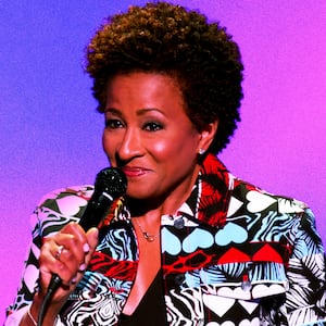 Photo illustration of Wanda Sykes performing standup on a purple and blue background