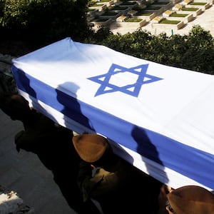 Israeli soldiers carry the flag draped coffin in 2014.