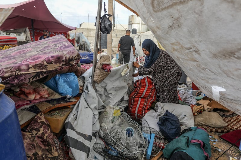 Palestinians inspect damage after an Israeli attack