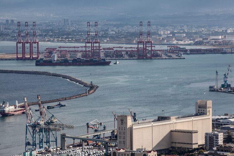 A photograph of cargo ships seen at Israel's Haifa commercial shipping port in the Mediterranean Sea on December 13, 2023. 