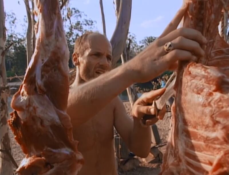 Michael Skupin butchers a pig during Survivor: The Australian Outback.