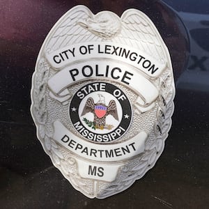 A police shield is displayed on a Lexington, Mississippi police cruiser