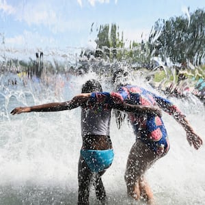 Children splash in the water to cool off from the heat wave in Washington, DC, earlier this week. 