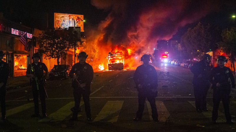 Dodger fans set off fireworks inside the abandoned bus on Sunset Boulevard and cause it to combust into flames after the Dodgers win the World Series game 7-6 against the New York Yankees. (Photo by Shay Horse/NurPhoto via Getty Images)