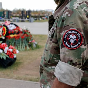 A man visits the grave of Dmitry Utkin, a commander of the Wagner mercenary group, while marking 40 days since Utkin and the group's chief Yevgeny Prigozhin's death at a cemetery in Mytishchi on the outskirts of Moscow, Russia,