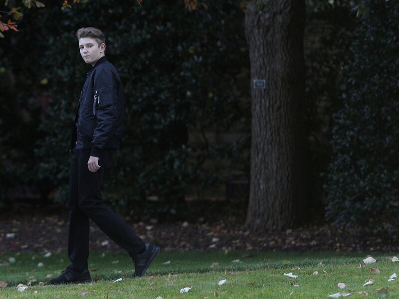 Barron Trump walks across White House lawn.