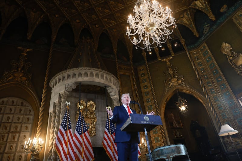 Donald Trump speaks behind podium.