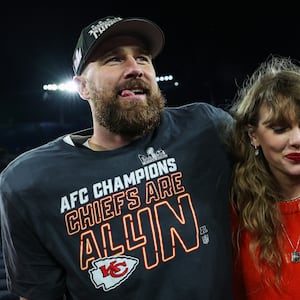 Travis Kelce #87 of the Kansas City Chiefs (L) celebrates with Taylor Swift after defeating the Baltimore Ravens