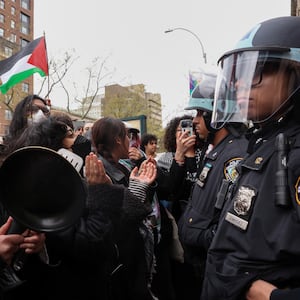 Police officers stand guard as demonstrators protest in solidarity with Pro-Palestinian organizers on the Columbia University campus, amid the ongoing conflict between Israel and the Palestinian Islamist group Hamas, in New York City