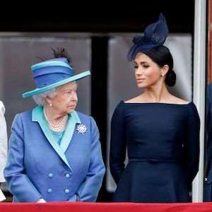 Queen Elizabeth II, Meghan, Duchess of Sussex and Prince Harry, Duke of Sussex watch a flypast to mark the centenary of the Royal Air Force from the balcony of Buckingham Palace on July 10, 2018 in London, England.