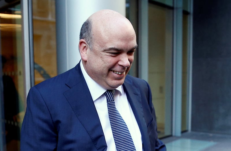 Mike Lynch smiles while exiting a courthouse.