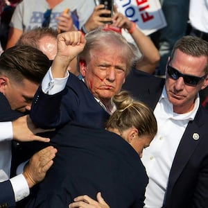 Donald Trump is seen with blood on his face surrounded by Secret Service agents as he is taken off the stage at a campaign event at Butler Farm Show Inc. in Butler, Pennsylvania, July 13, 2024.