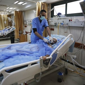 Sick and injured Palestinians receive treatment with limited facilities at the Al-Aqsa Martyrs Hospital in Deir al-Balah, Gaza.