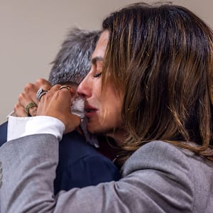 Actor Alec Baldwin and his wife, Hilaria, hug following the dismissal