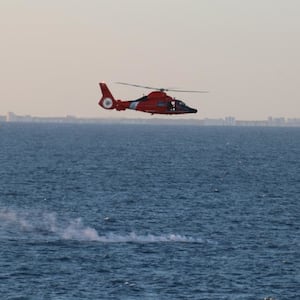 A Coast Guard helo is overflying the debris site