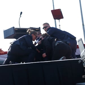 Former President Donald Trump is rushed offstage during a rally on July 13, 2024 in Butler, Pennsylvania. 