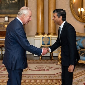 King Charles III greets newly appointed Conservative Party leader and incoming prime minister Rishi Sunak during an audience at Buckingham Palace in London on October 25, 2022