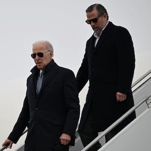 Joe Biden and Hunter Biden walking down stairs from a plane.