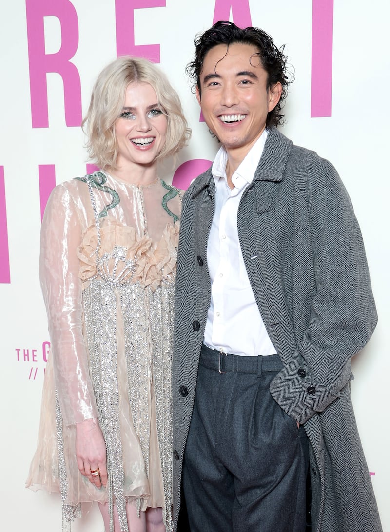 A photo of Lucy Boynton and Justin Min on a step