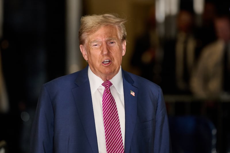 Former President Donald Trump speaks to the media as he enters Manhattan Criminal Court.