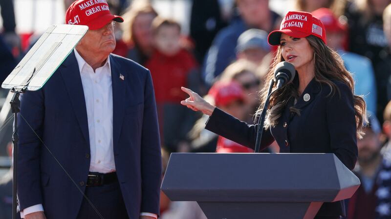 Former US President and Republican presidential candidate Donald Trump listens as North Dakota Governor Kristi Noem speaks during a Buckeye Values PAC Rally in Vandalia, Ohio, on March 16, 2024. 