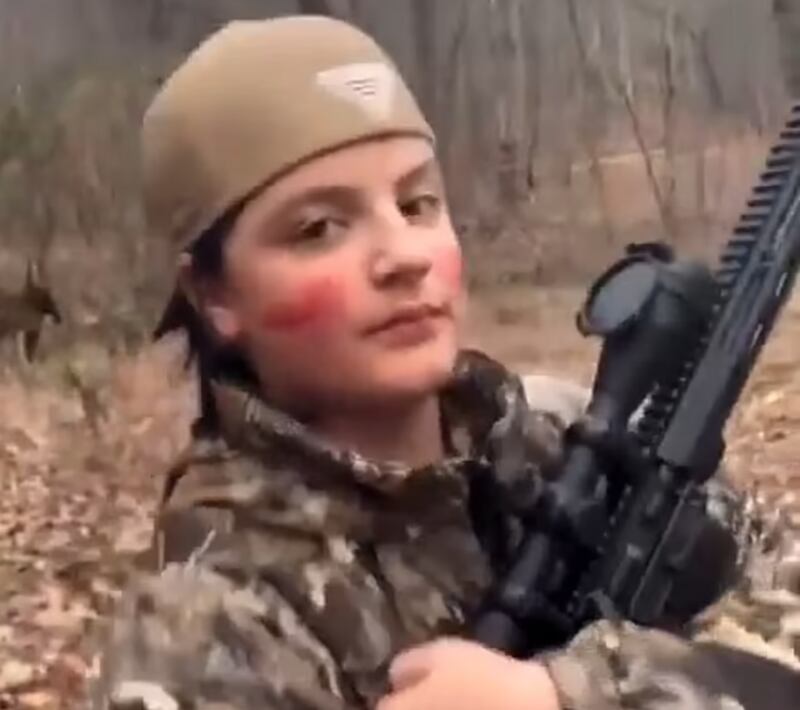 Colt Gray poses with a rifle.