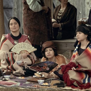 Lily Gladstone and the cast of Killers of the Flower Moon sitting in a still 