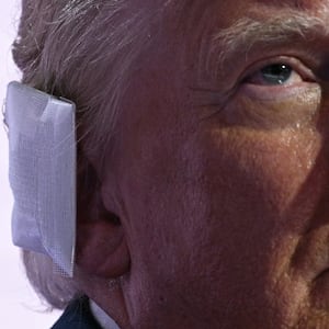 Donald Trump wears a bandage on his ear after surviving an assassination attempt as he stands onstage during the last day of the 2024 Republican National Convention at the Fiserv Forum in Milwaukee, Wisconsin, on July 18, 2024.