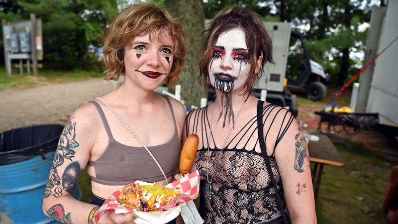 Two fans pose together at the 2023 Gathering of the Juggalos