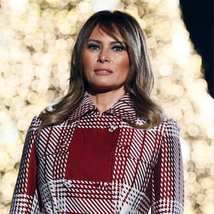 Melania Trump in front of a Christmas tree (left), ornaments with Melania Trump's "Be Best" initiative slogan written on them hang on a tree (right)