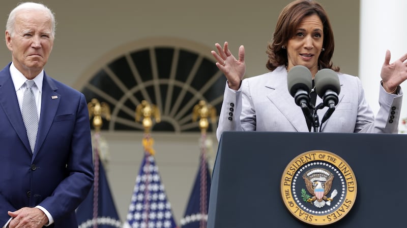 Vice President Kamala Harris (R) speaks as President Joe Biden listens.