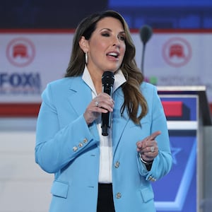 Ronna McDaniel holds a microphone as she speaks on stage before a Republican presidential primary debate.